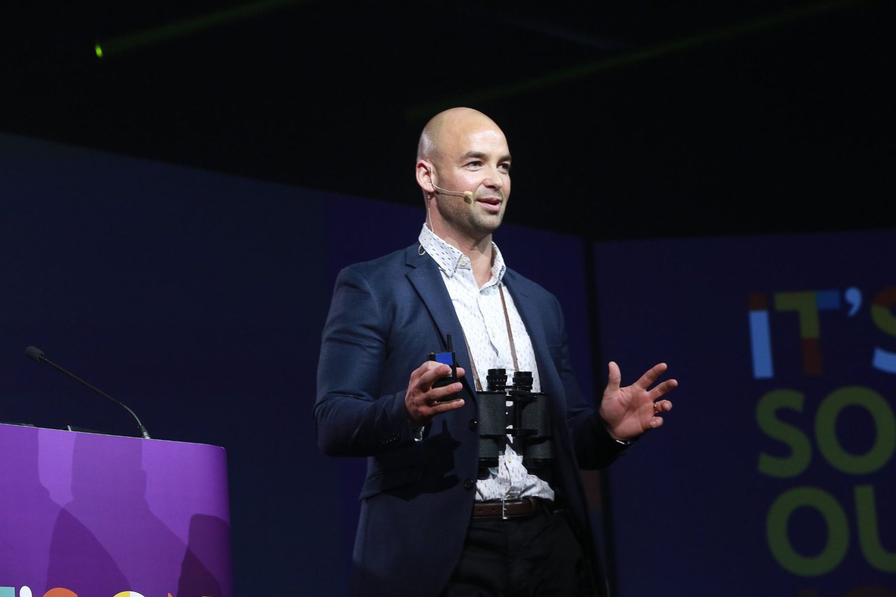Joel gesturing mid-story on a conference stage